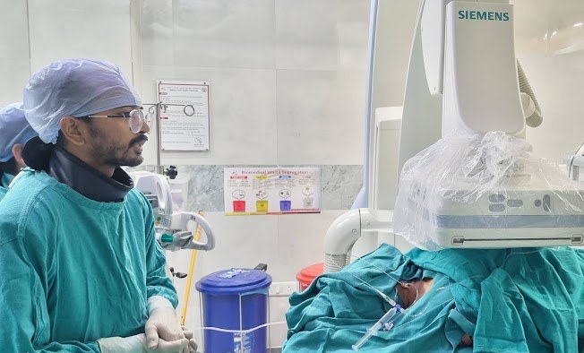 Dr. Bhaskar Das performing an image-guided procedure in the interventional radiology suite